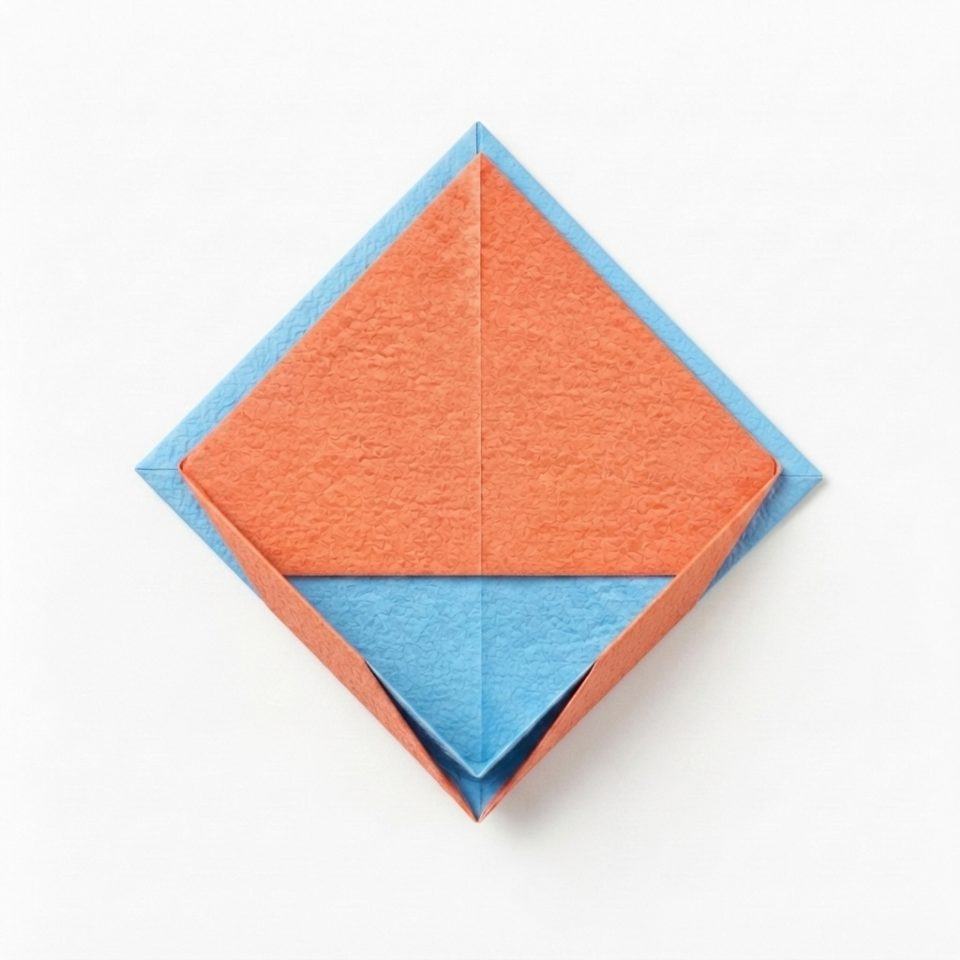A flattened coral and blue paper diamond with an opening at its bottom point.