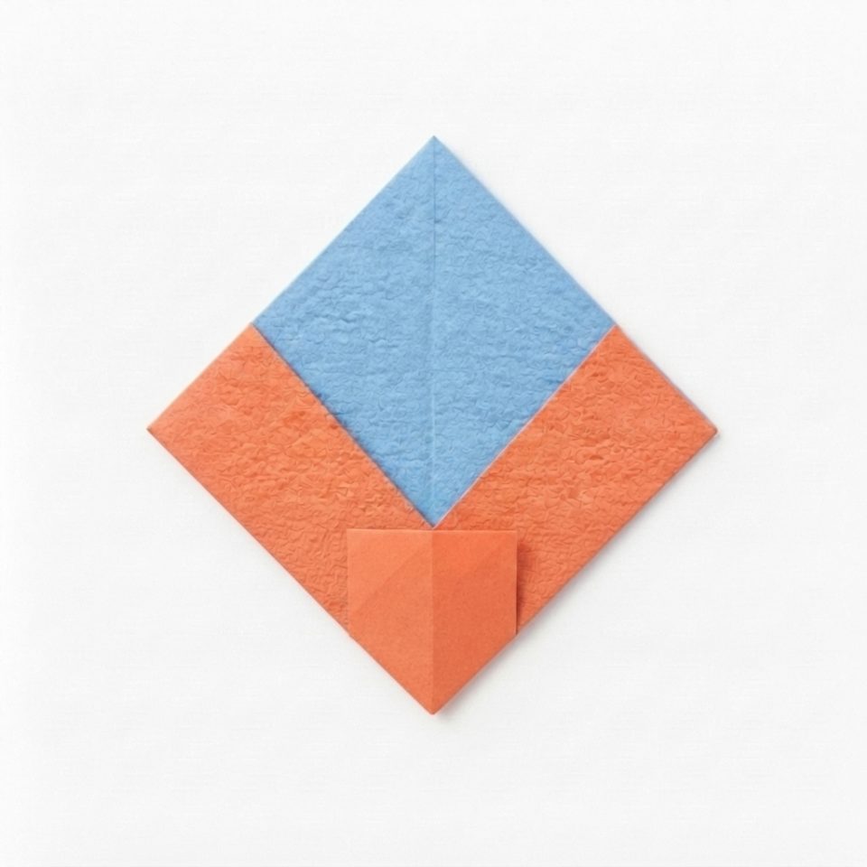 A coral and blue folded paper diamond with the lower point folded up.